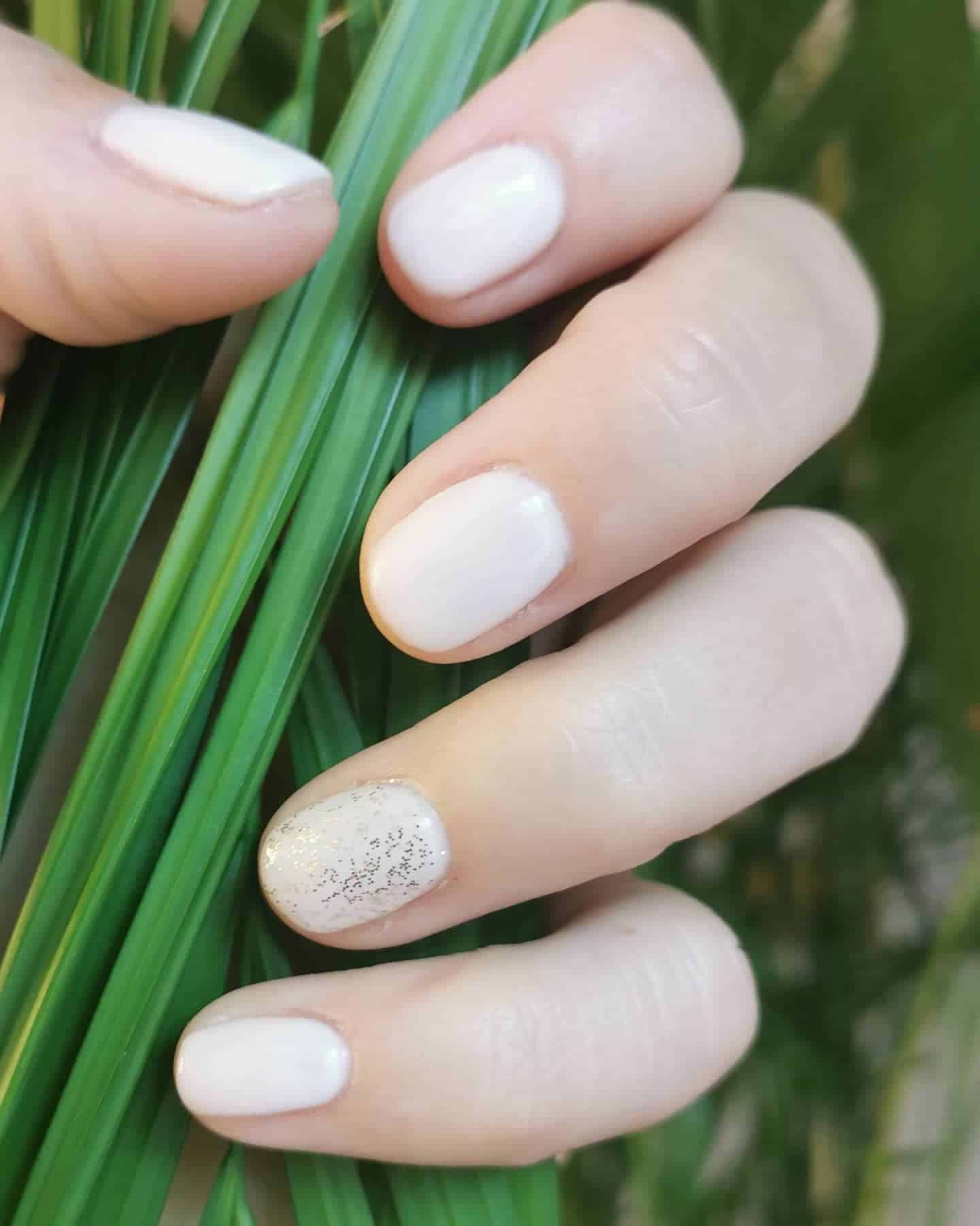 5. Subtle Pearl with Spark Accent - accent nail ideas
