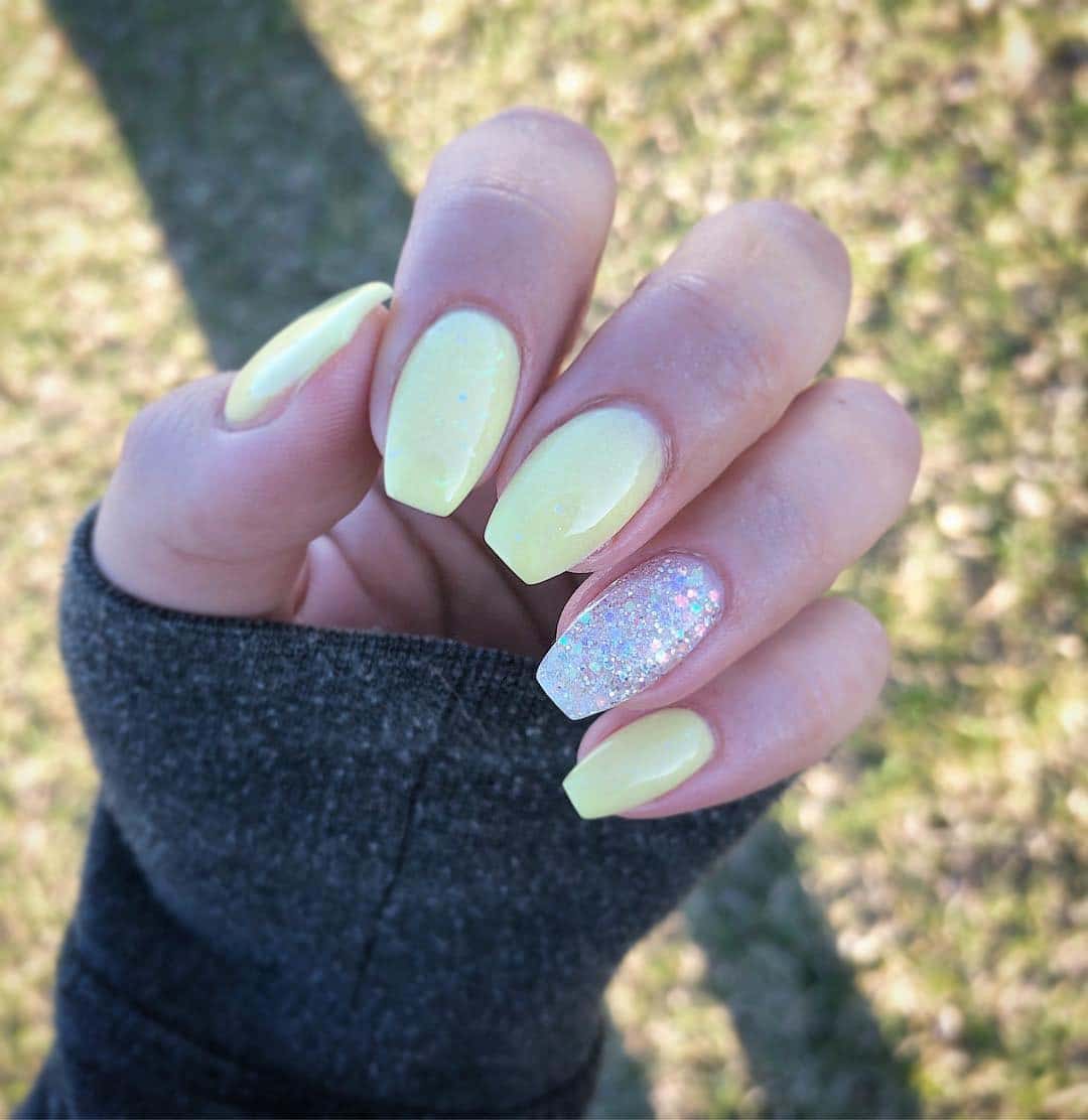 13. Soft Lemon with Glitter Pop - accent nail ideas
