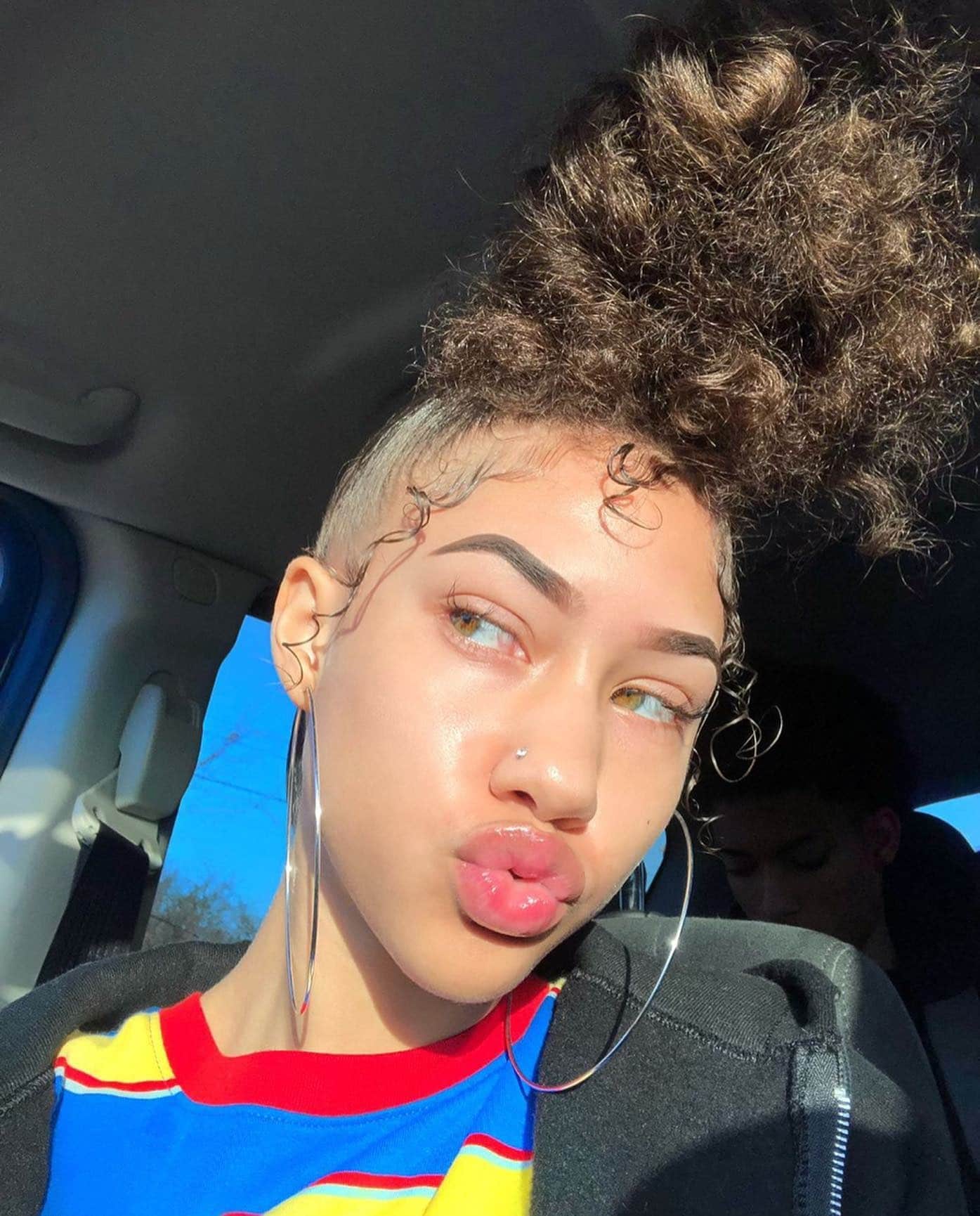 1. High Curly Bun with Sleek Edges – Natural Brown - Baddie Hairstyles