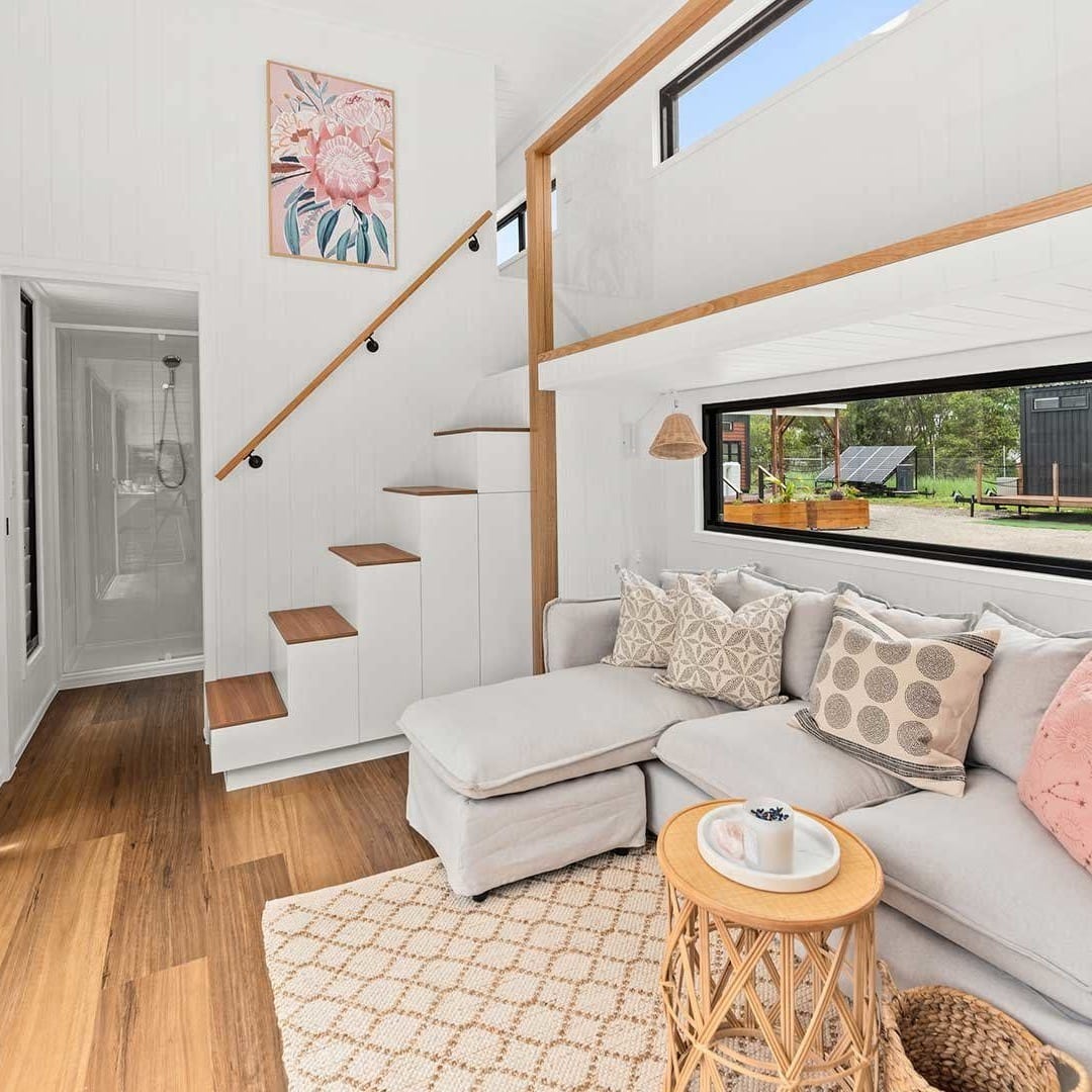 15. Soft White Interior with Subtle Pastels - tiny house living room ideas