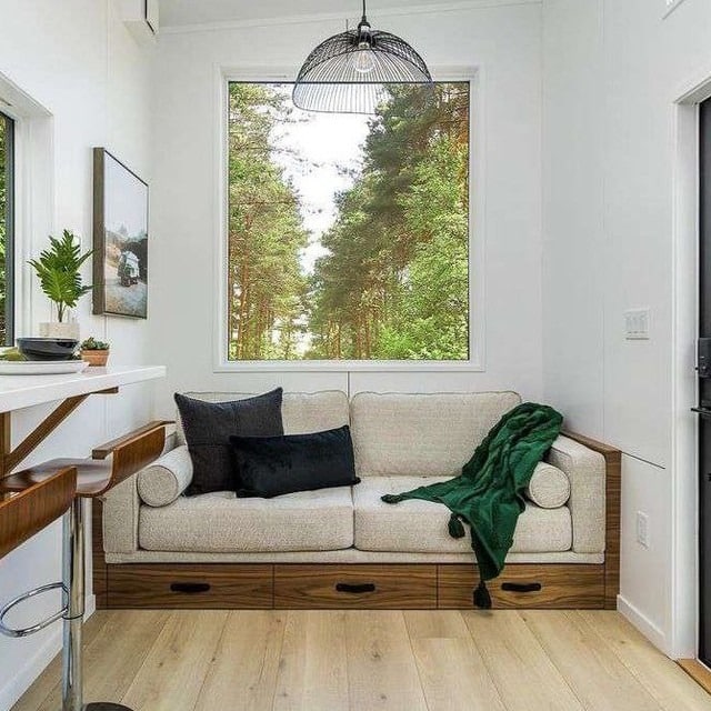 21. Neutral Comfort Framed by Nature - tiny house living room ideas