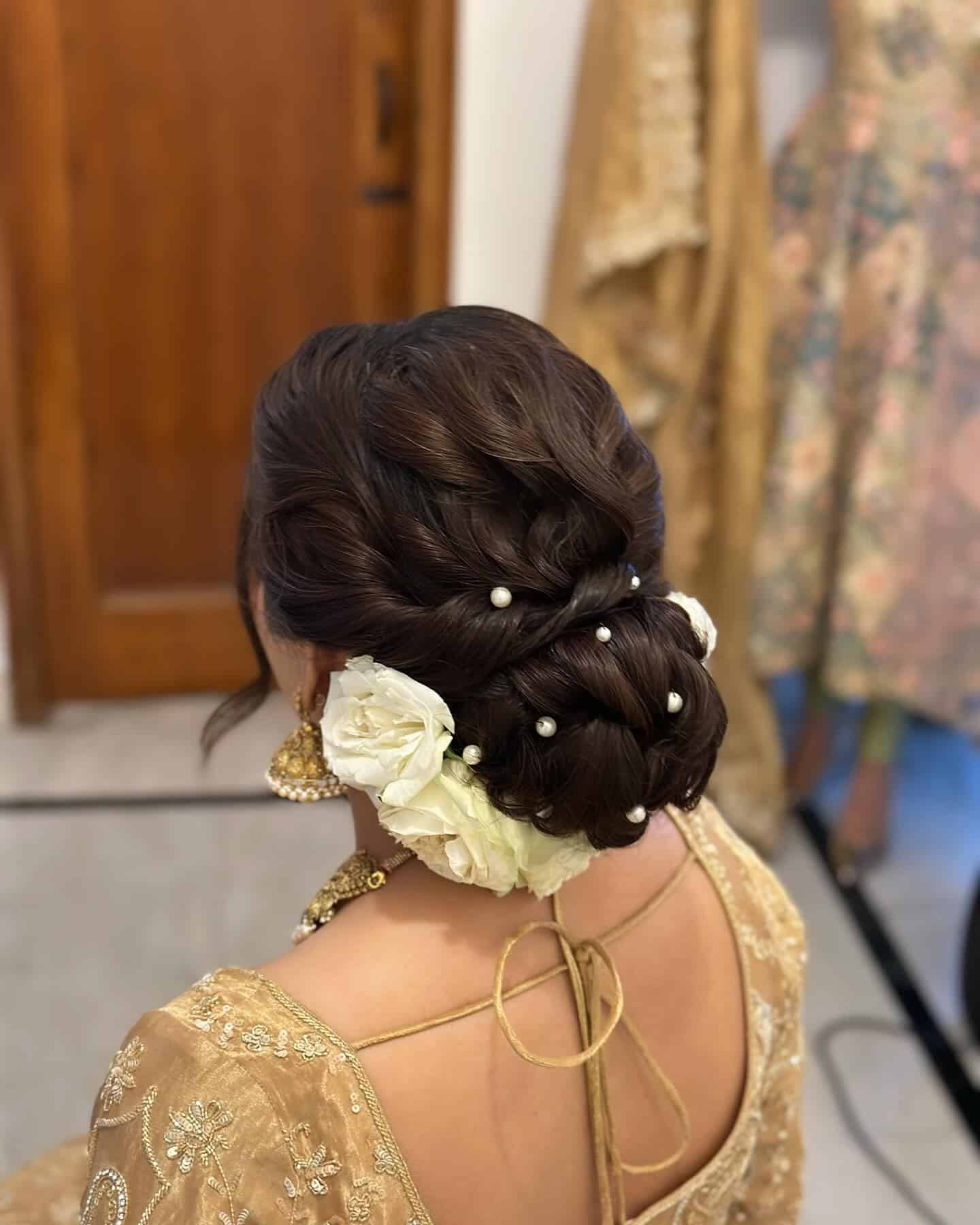 3. Braided Bun with Pearls and White Flowers - Bun Hairstyles