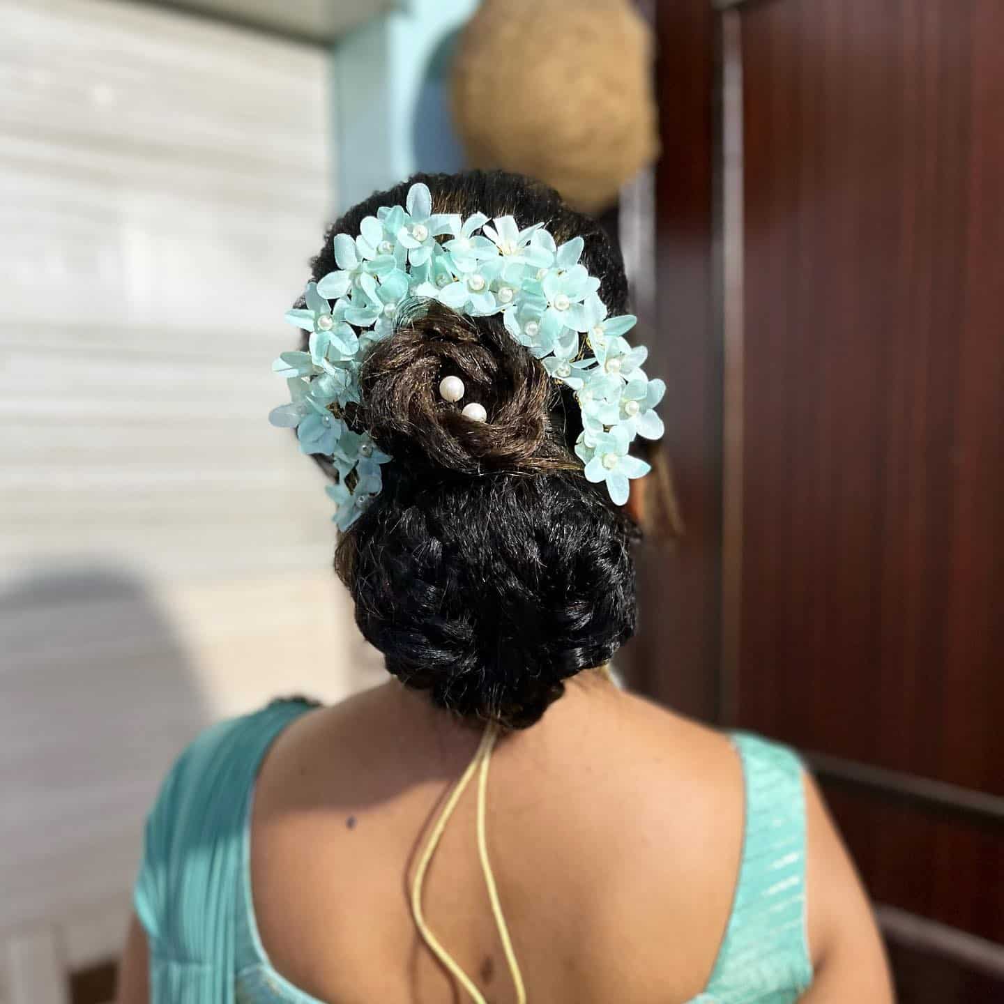 4. Textured Bun with Aqua Floral Crown - Bun Hairstyles