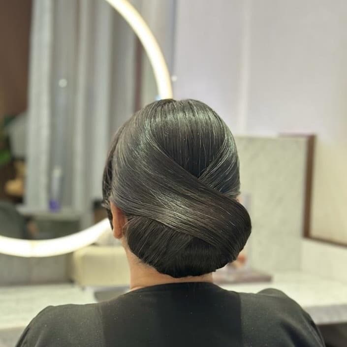 7. Polished Crossover Low Bun - Bun Hairstyles