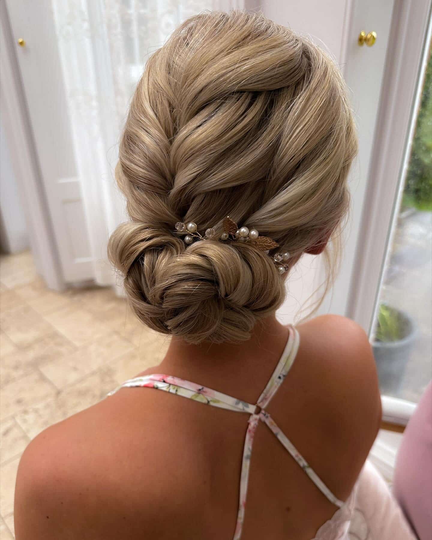 10. Twisted Low Bun with Pearl Accessories - Bun Hairstyles