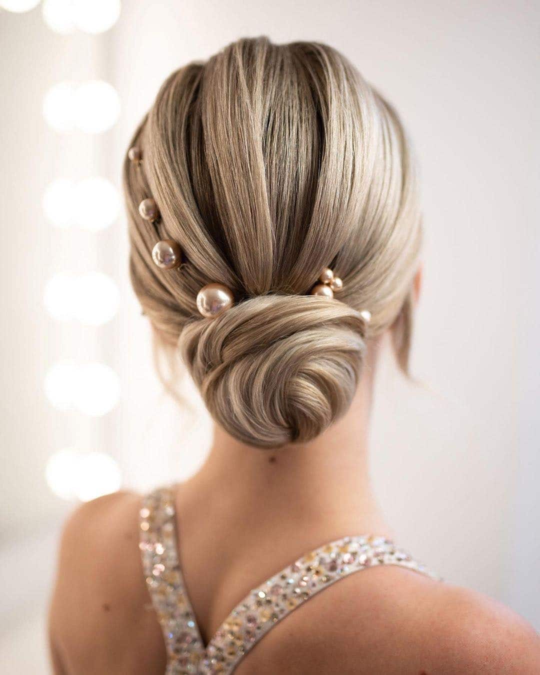 12. Elegant Low Twist Bun with Pearl Detailing on Ash Blonde Hair - Bun Hairstyles