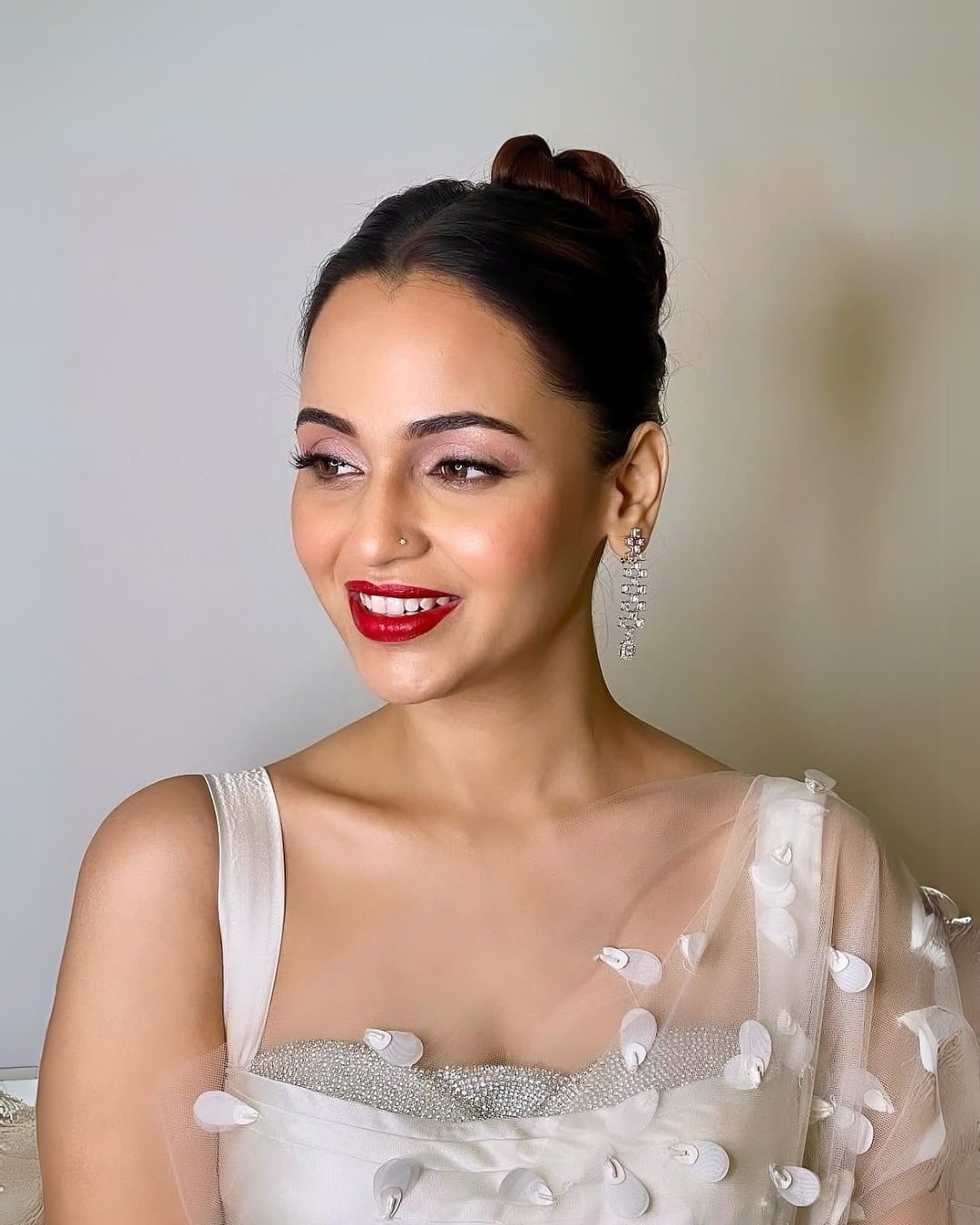 13. Classic Sleek Top Bun on Deep Brown Hair - Bun Hairstyles