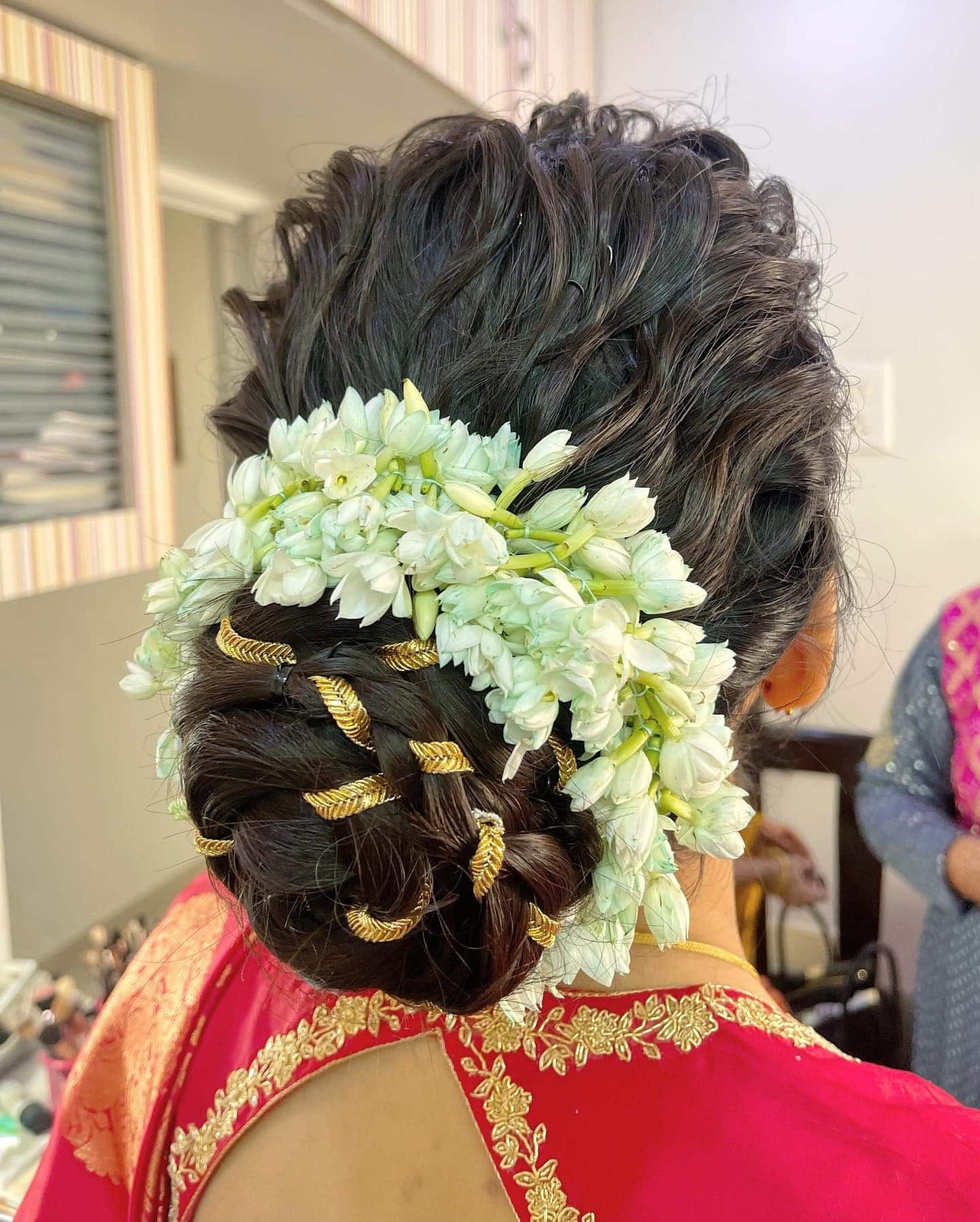 14. Braided Bun with Gold Accents and Jasmine Flowers on Black Hair - Bun Hairstyles