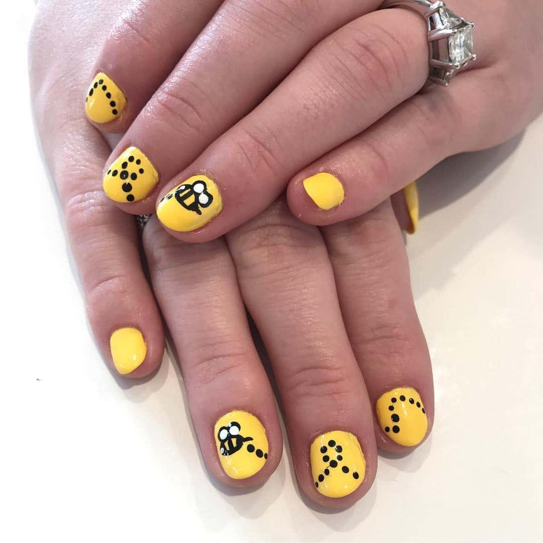 9. Minimalist Yellow Bee Nails - bee nail ideas