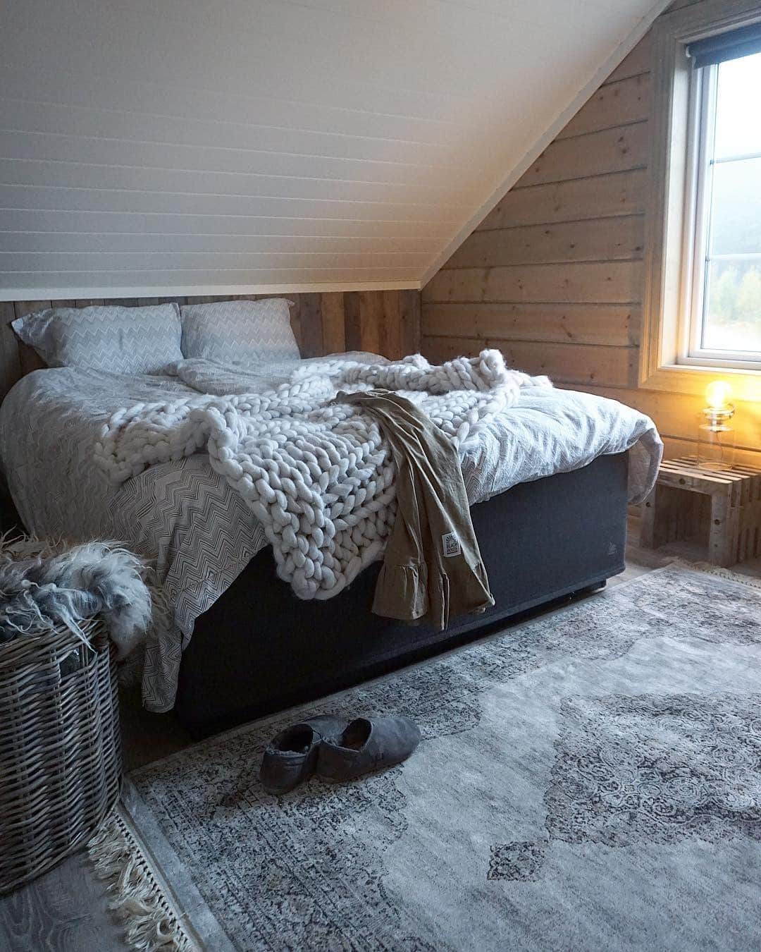 6. Cozy Alpine Charm with Chunky Knits - cabin bedroom ideas