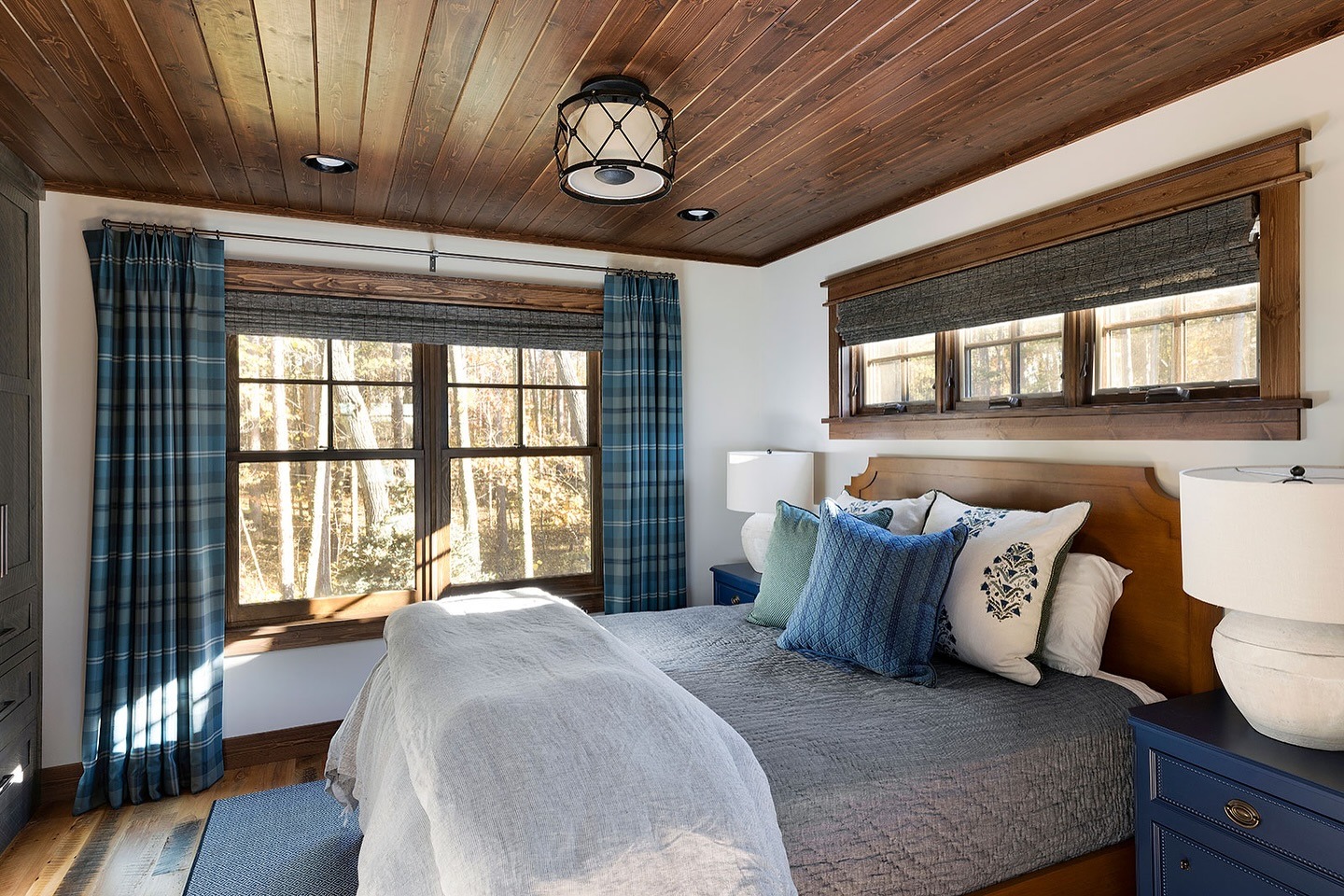 8. Classic Cabin Elegance with Blue Accents - cabin bedroom ideas