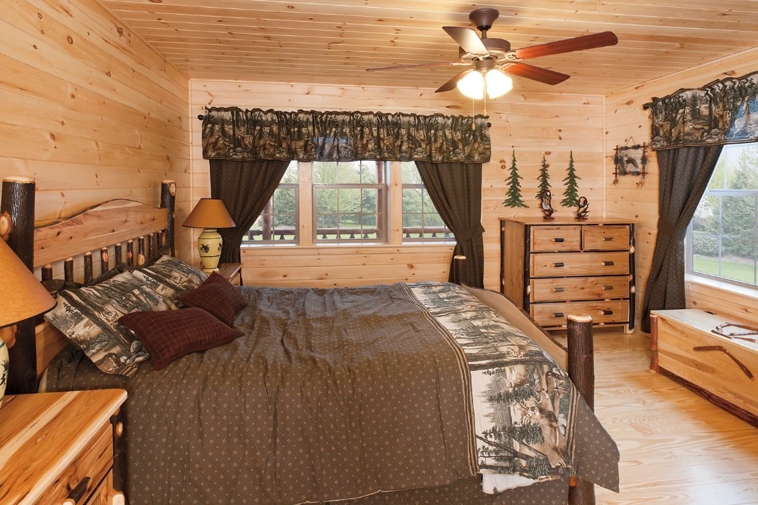11. Traditional Cabin Charm with Woodland Prints - cabin bedroom ideas