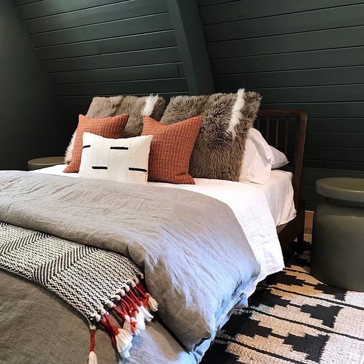 15. Moody Cabin Retreat with Deep Green Walls - cabin bedroom ideas