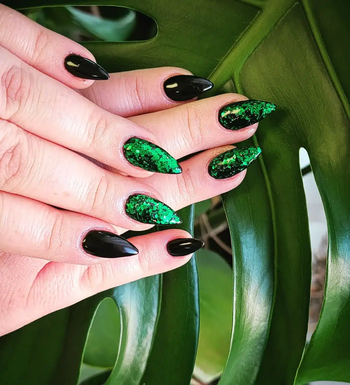 1. Emerald Sparkle Stilettos - black and green nail ideas