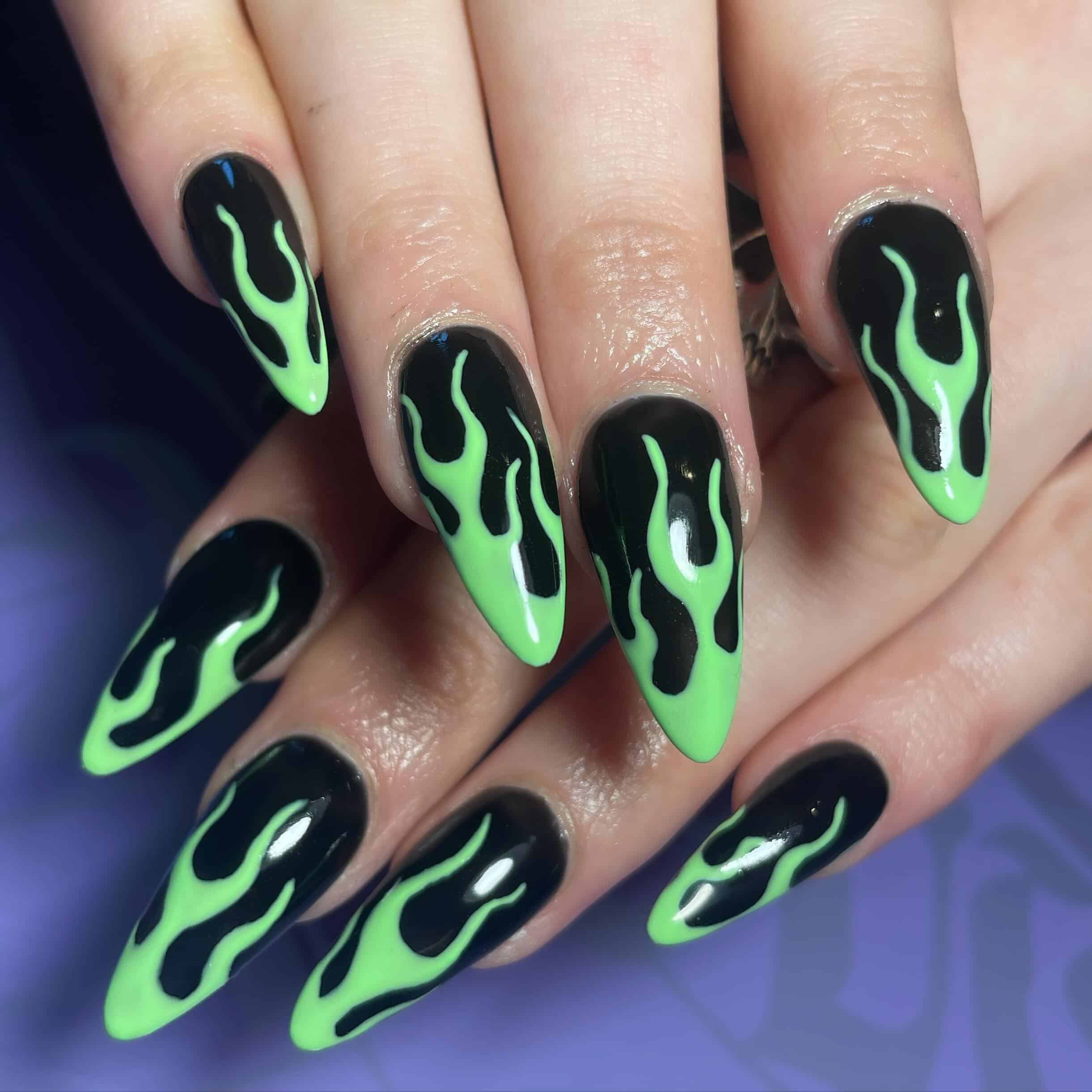 4. Toxic Flame Stiletto Nails - black and green nail ideas