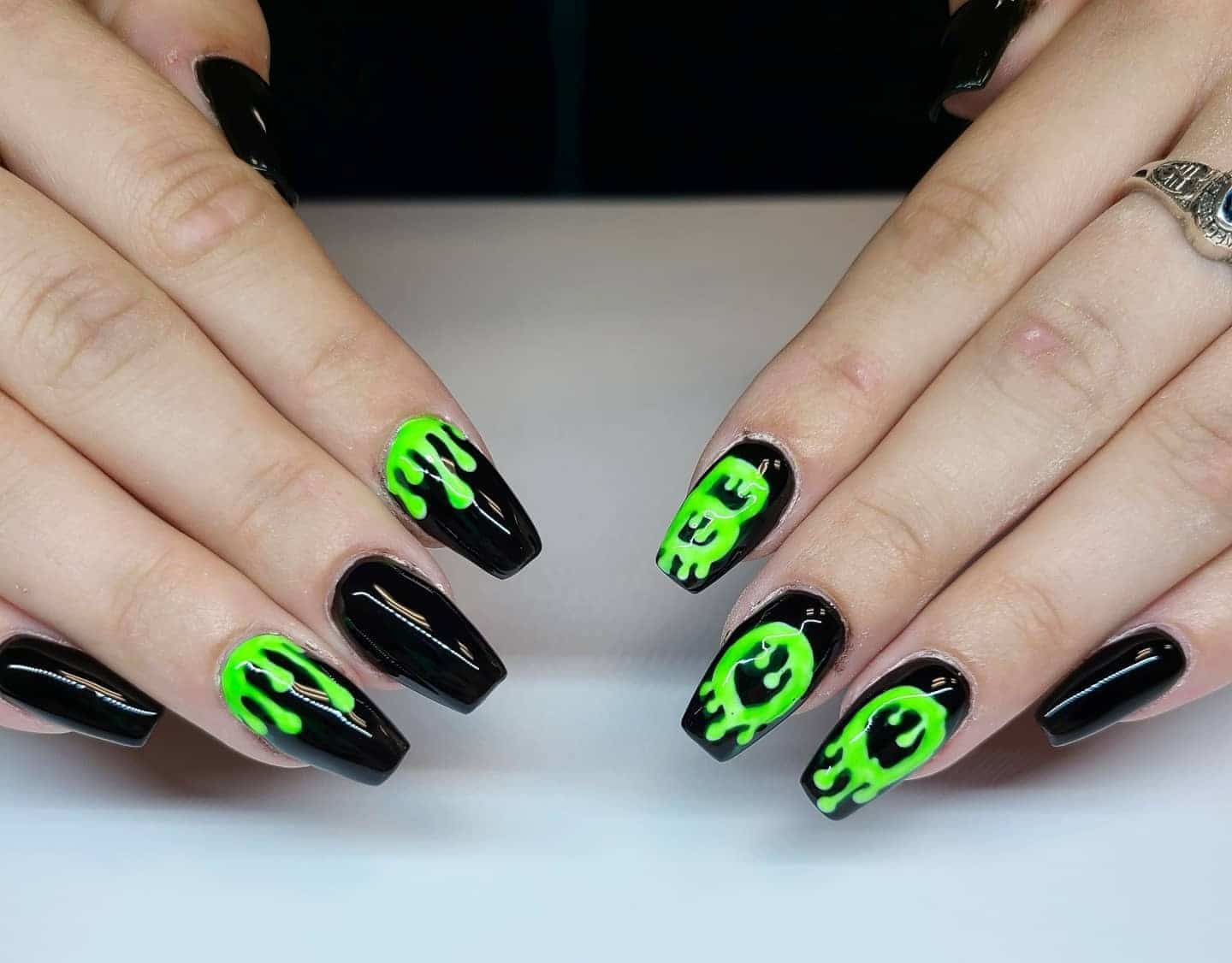 8. Neon Slime Drip Art - black and green nail ideas