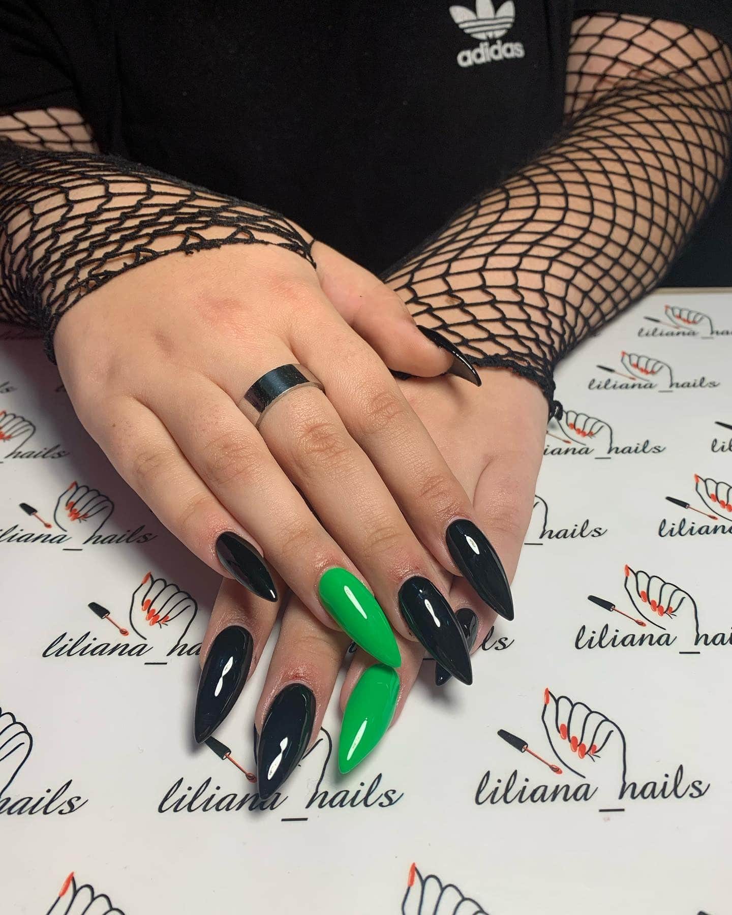 19. Pop of Neon Stilettos - black and green nail ideas