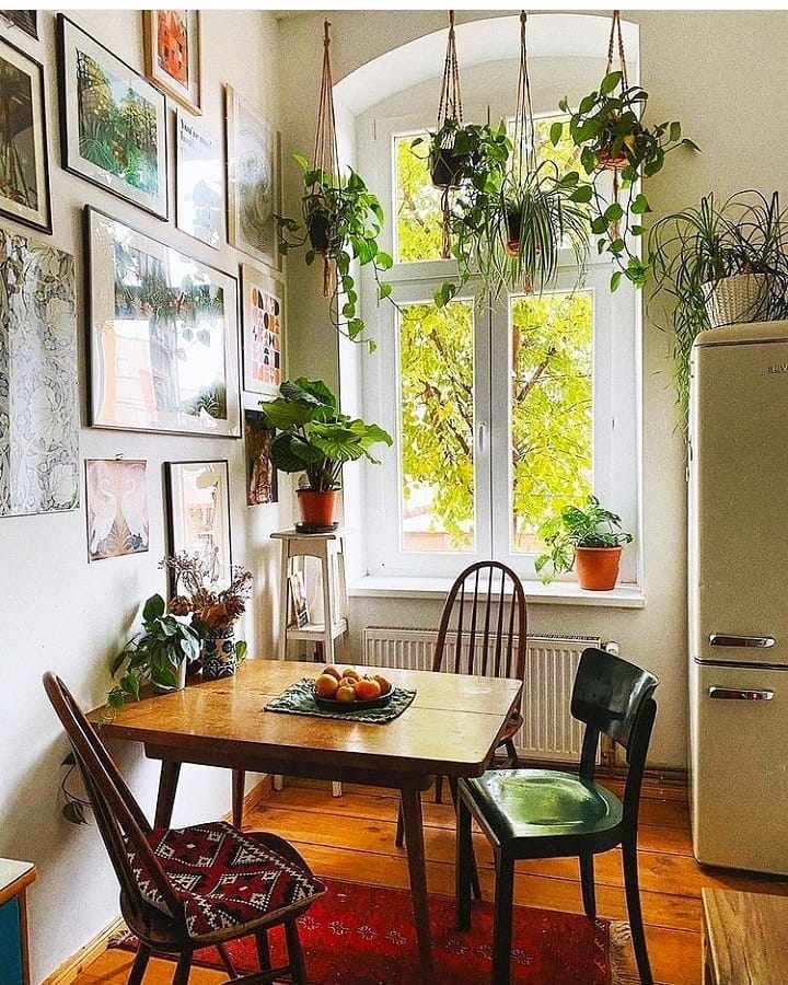 7. Eclectic Greenery and Artistic Flair - small kitchen table ideas