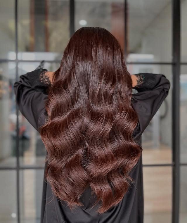 1. Glossy Chestnut Waves - Soft Brown Hair Color