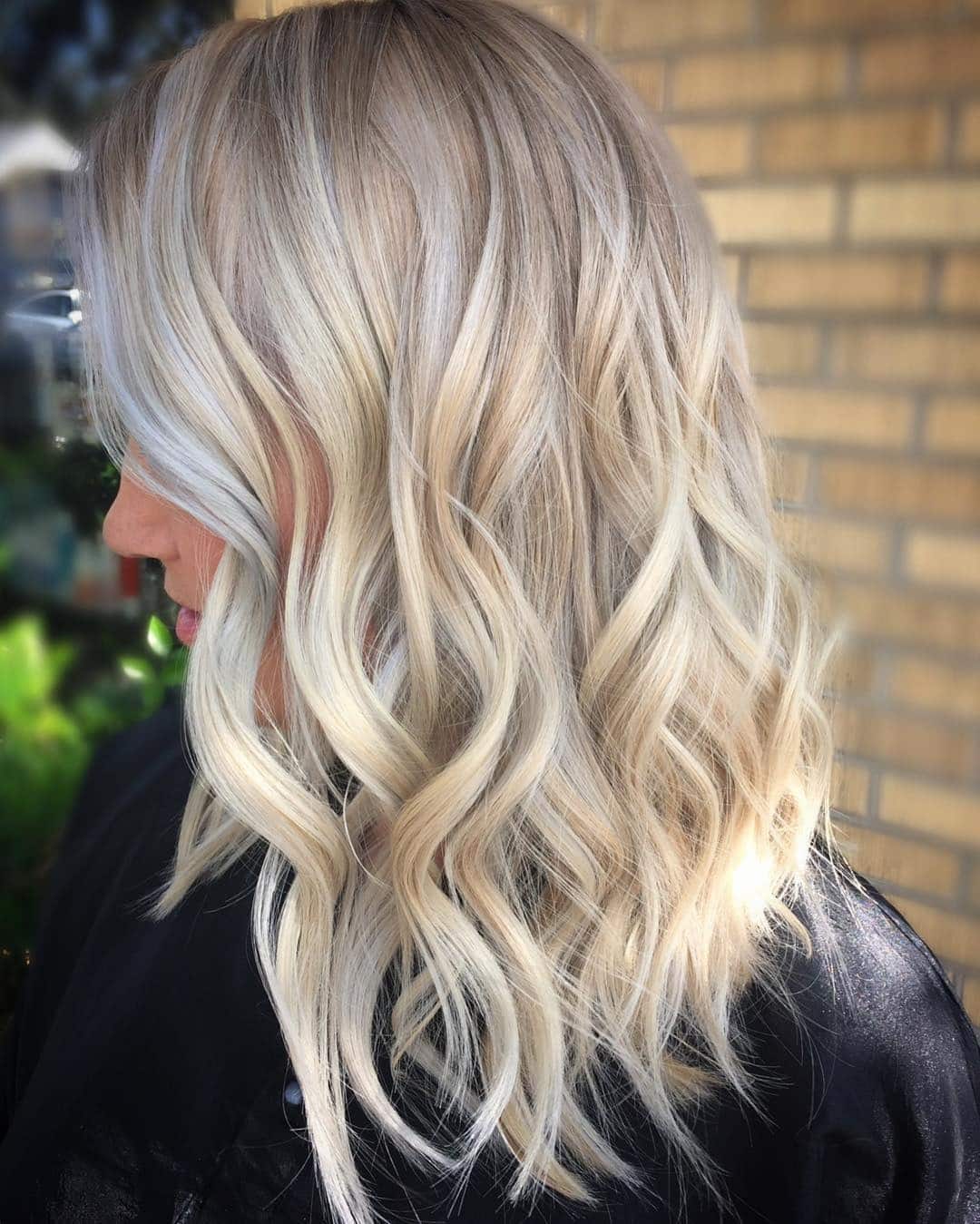 7. Ashy Blonde Curls with Subtle Depth - Ash Hair Color