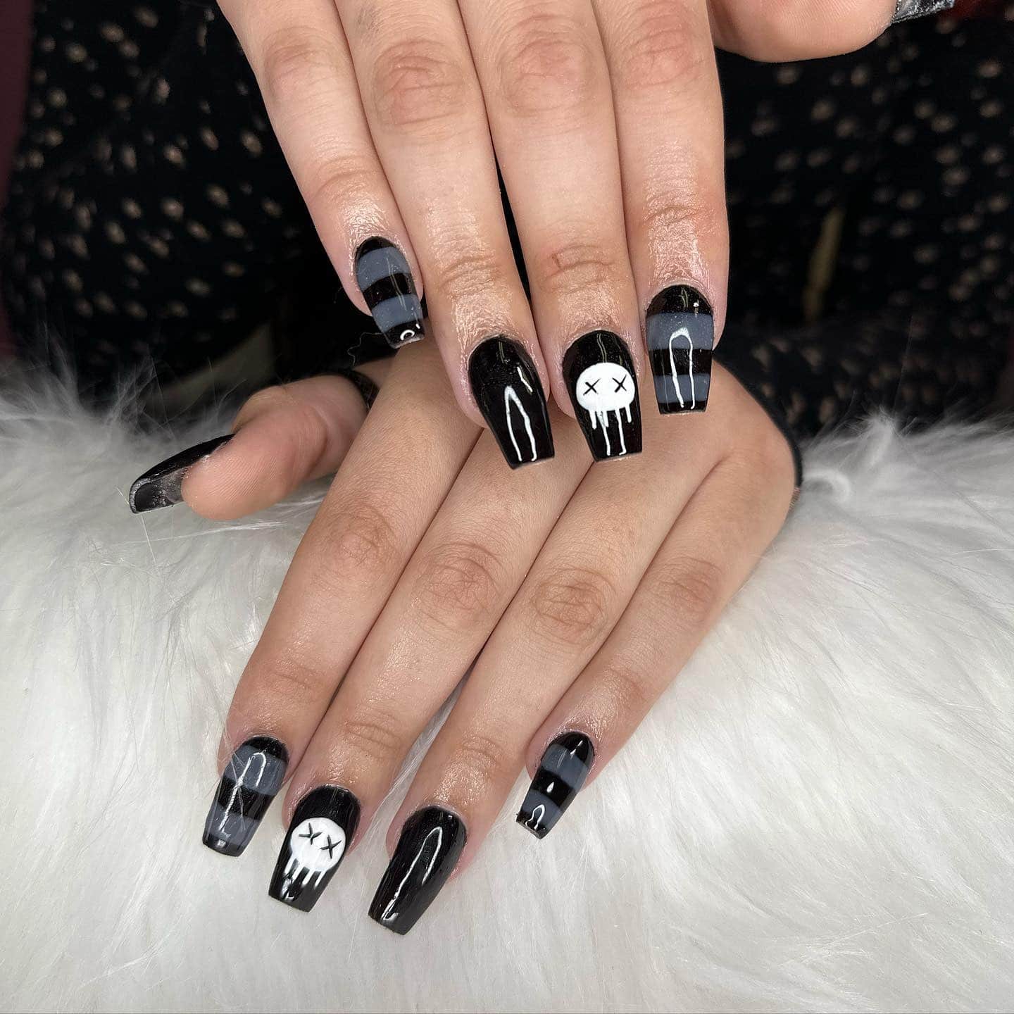 14. Edgy Black with Skull Detail - black and grey nail ideas