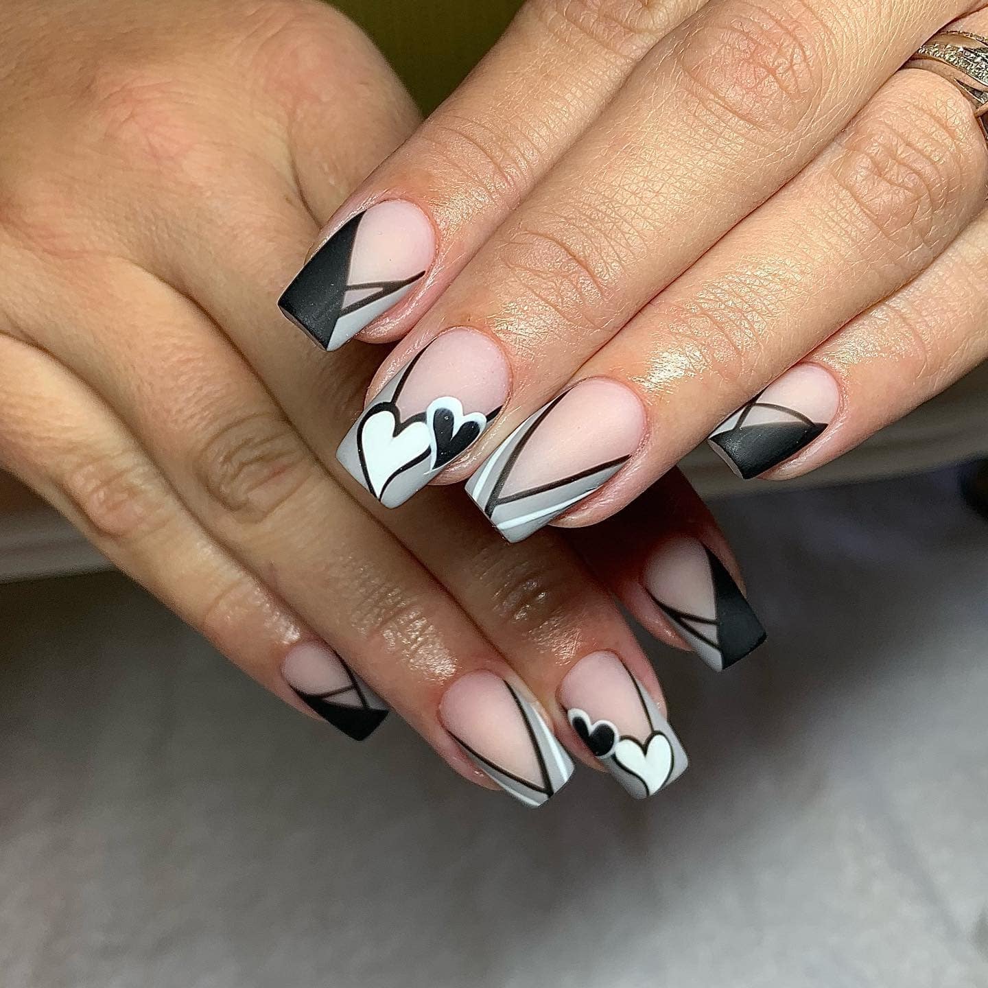 16. Geometric Hearts in Black and White - black and grey nail ideas