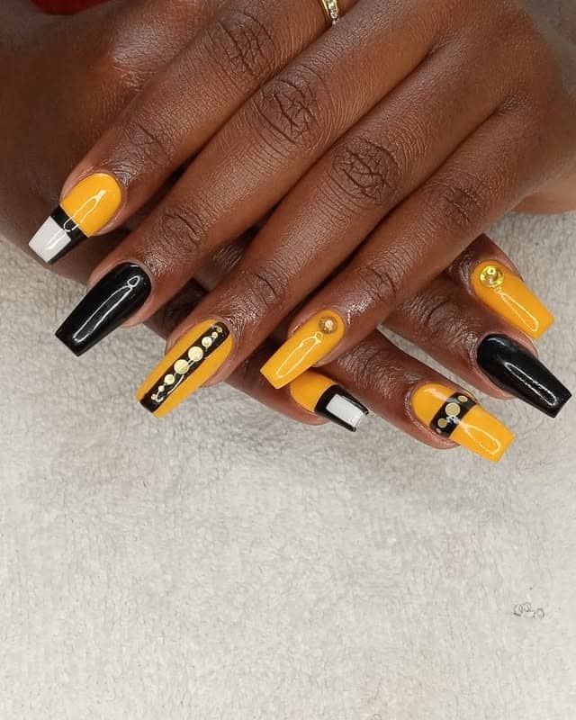 2. Geometric Chic with Yellow and Black - black and yellow nail ideas