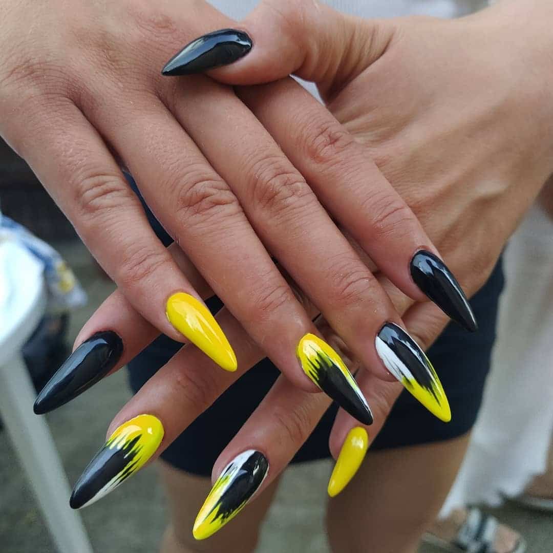 16. Bold Stiletto Brushstroke Nails - black and yellow nail ideas