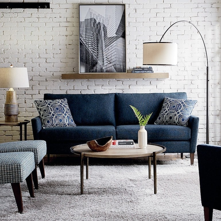 9. Industrial Character Meets Comfort - navy blue couch living room ideas