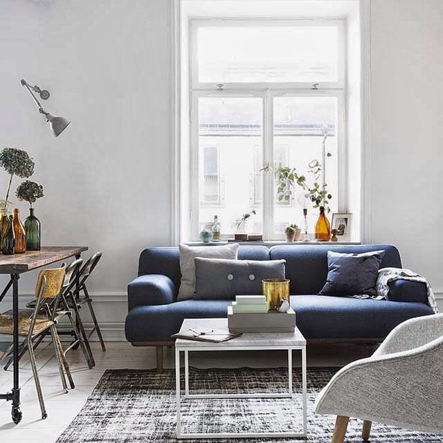 10. Casual Scandinavian Ease - navy blue couch living room ideas