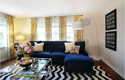 21. Bold Contrast with Graphic Patterns - navy blue couch living room ideas