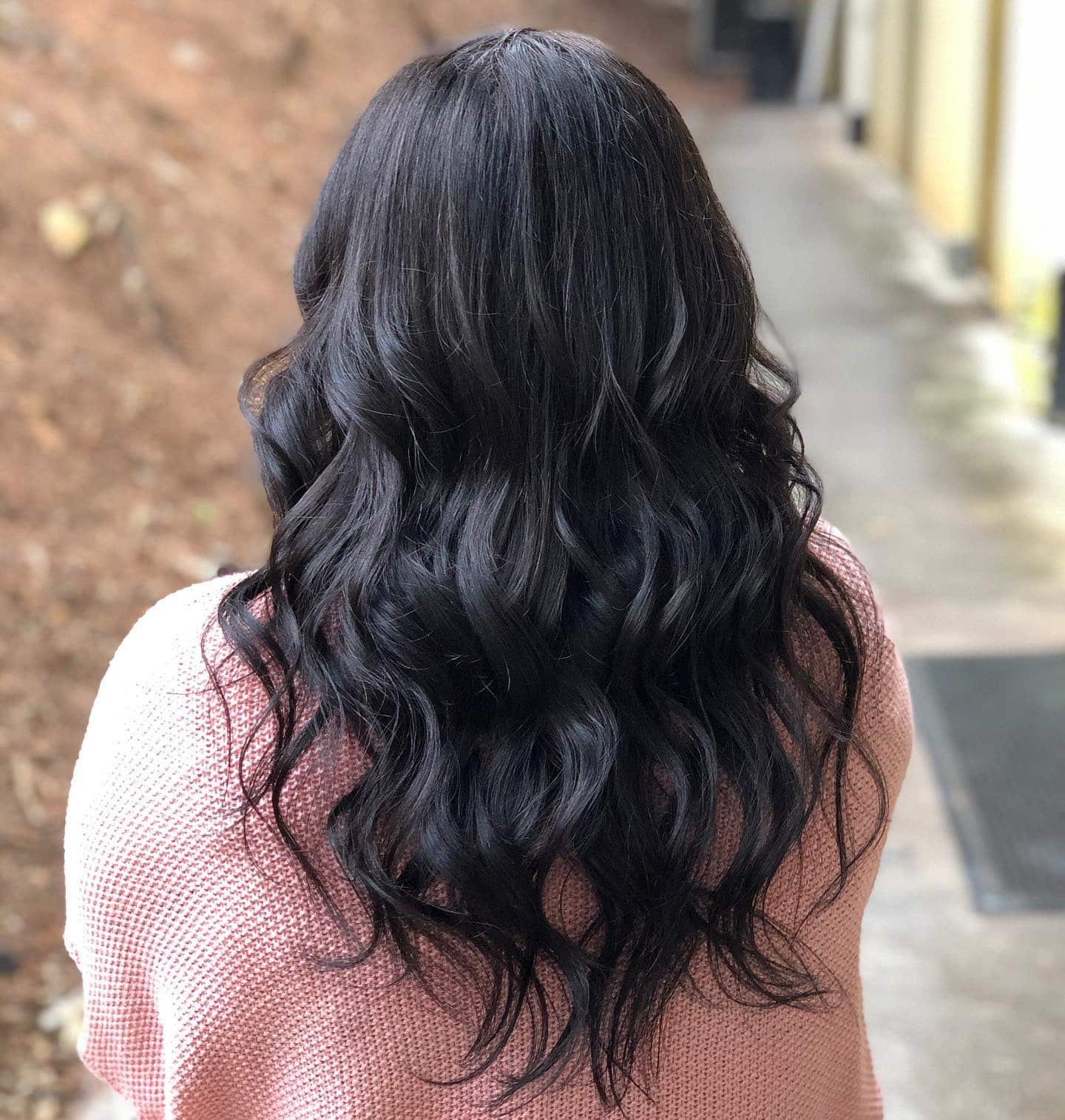 14. Cascading Layers with Soft Black Waves - Soft Black Hair Color