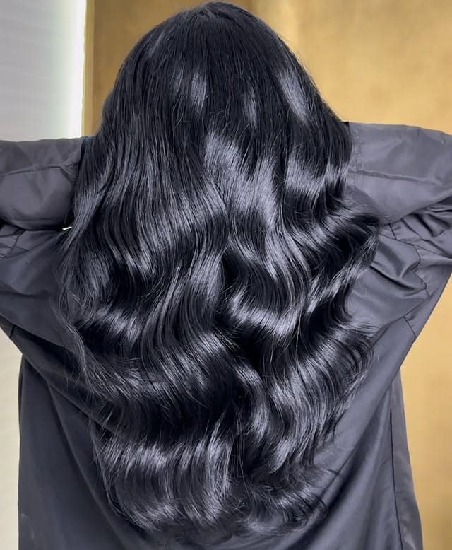 17. Glossy Hollywood Waves in Soft Black - Soft Black Hair Color