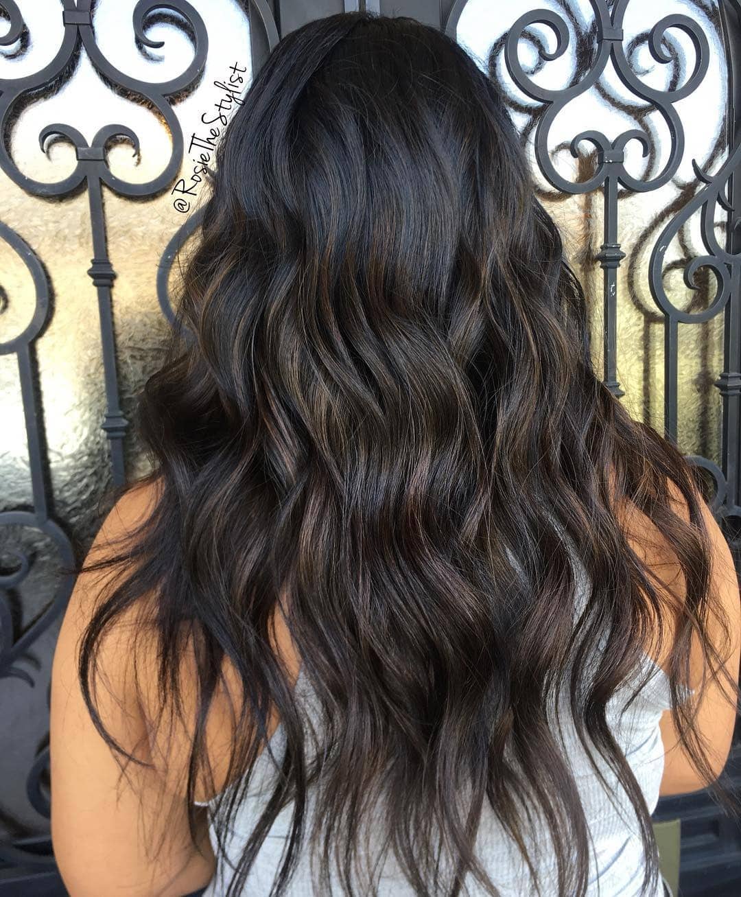22. Soft Black Waves with Subtle Brown Accents - Soft Black Hair Color