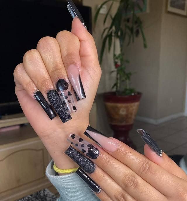 4. Edgy Black with Glitter and Heart Accents - black valentine nail ideas