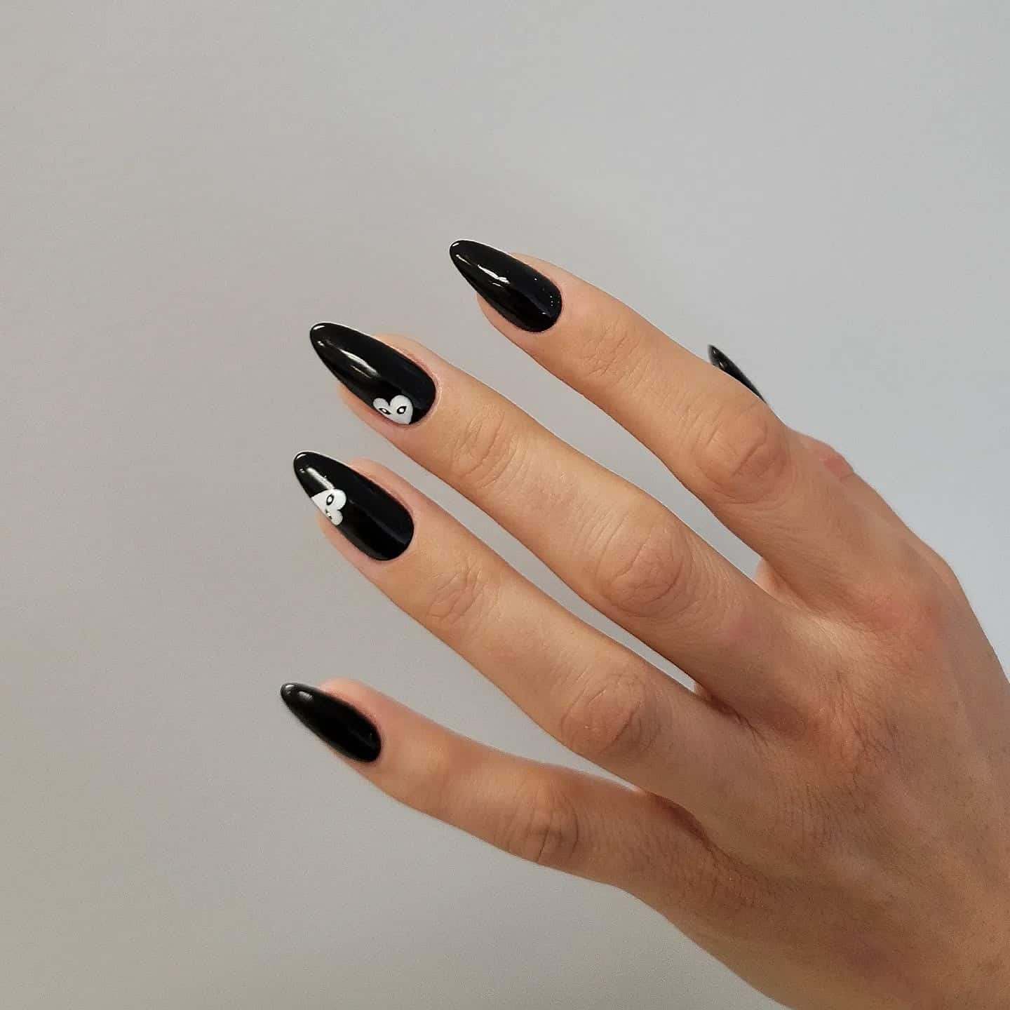 18. Glossy Black with White Eyes - black valentine nail ideas