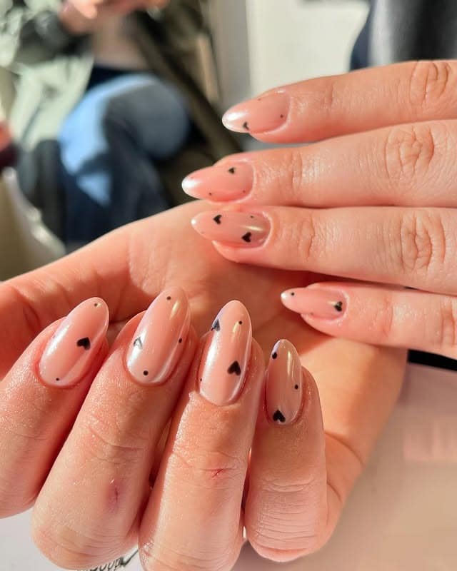 22. Scattered Mini Black Hearts - black valentine nail ideas