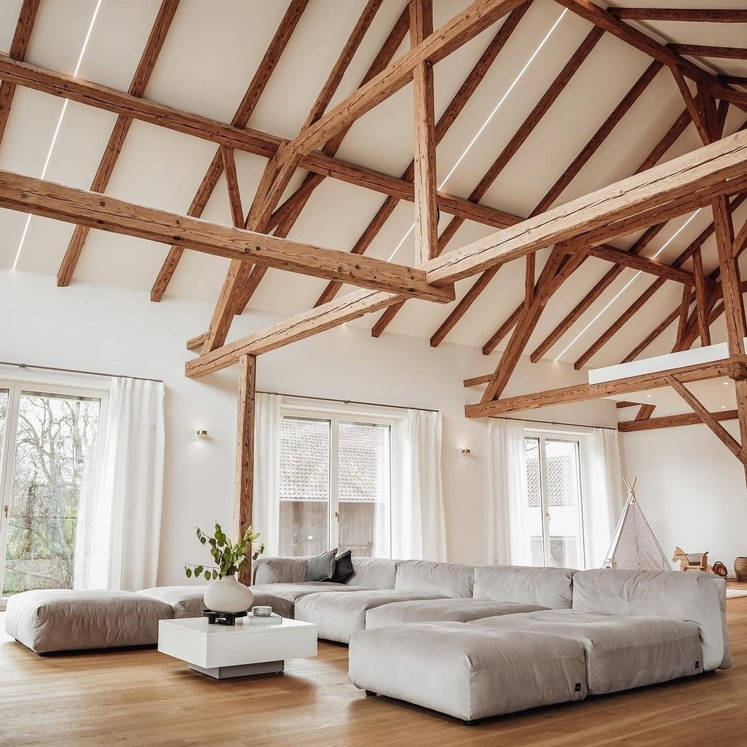 11. Rustic Elegance with Exposed Beams - open living room ideas