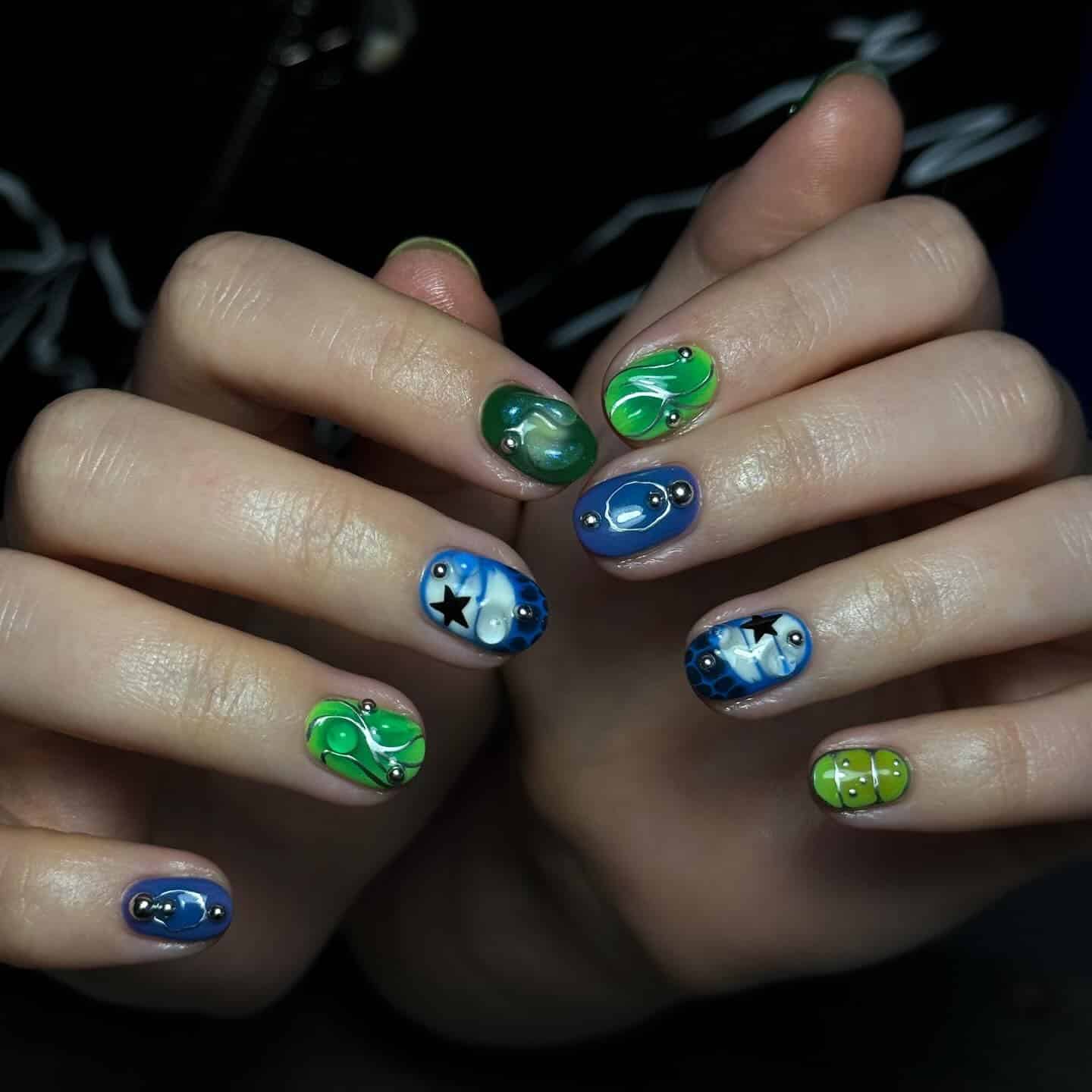 22. Cosmic Accent Art Nails - blue and green nail ideas