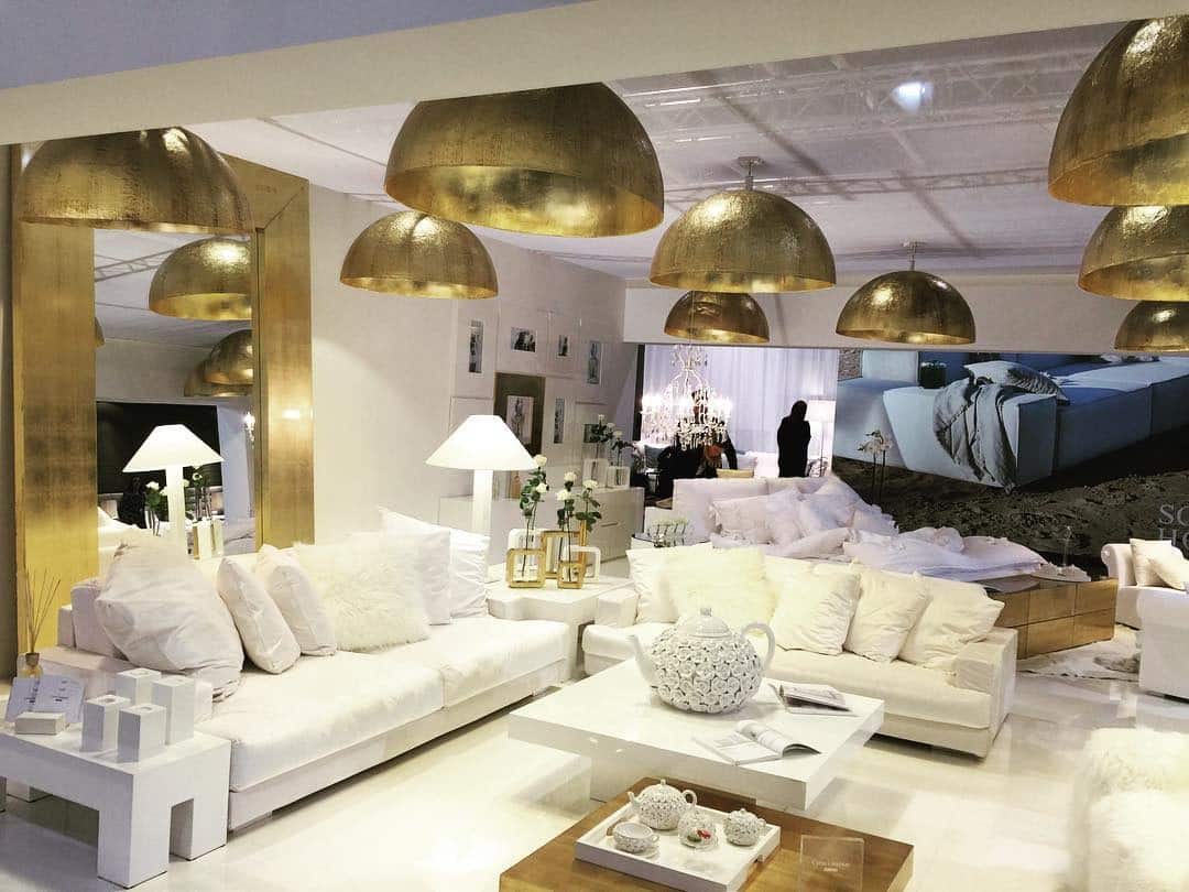 7. Chic Monochrome with Statement Gold Lighting - white and gold living room ideas