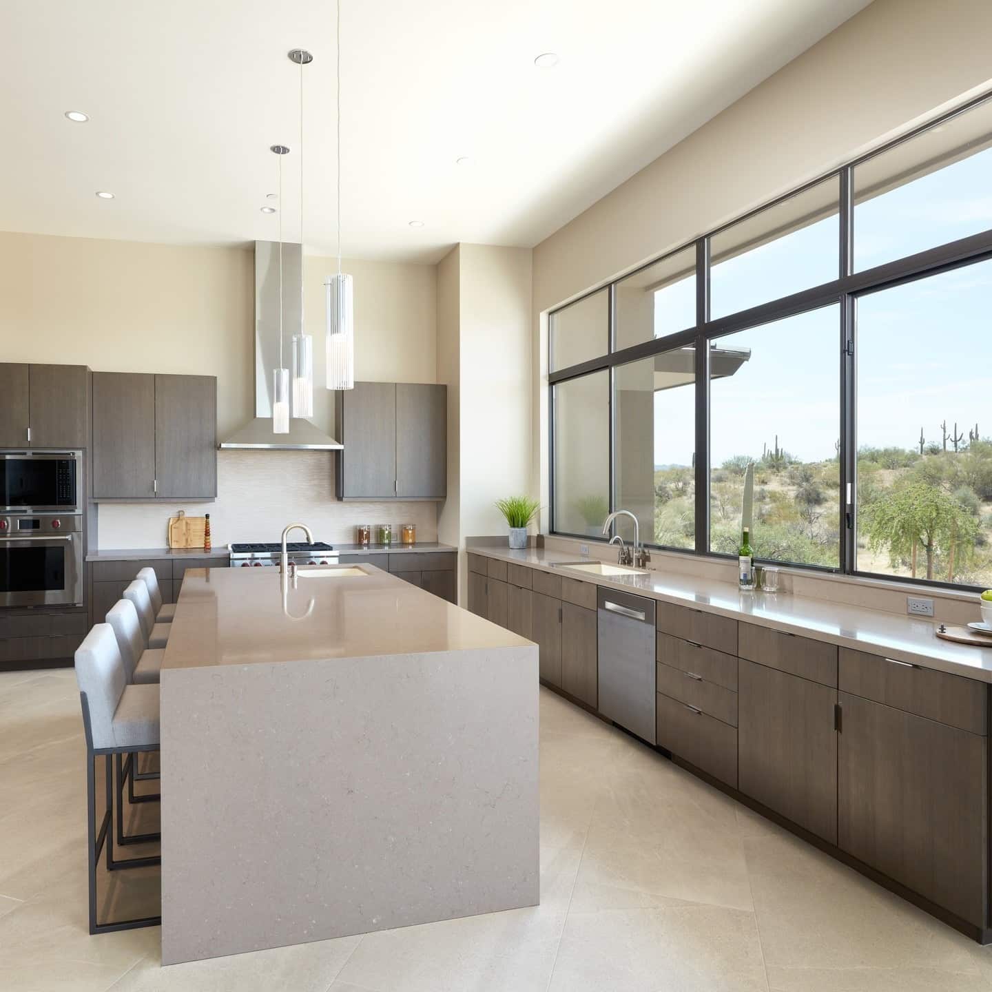 11. Soft Taupe Elegance with Expansive Windows - earth tones kitchen ideas