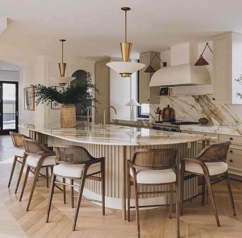 22. Curved Island with Warm Stone and Cane Seating - earth tones kitchen ideas