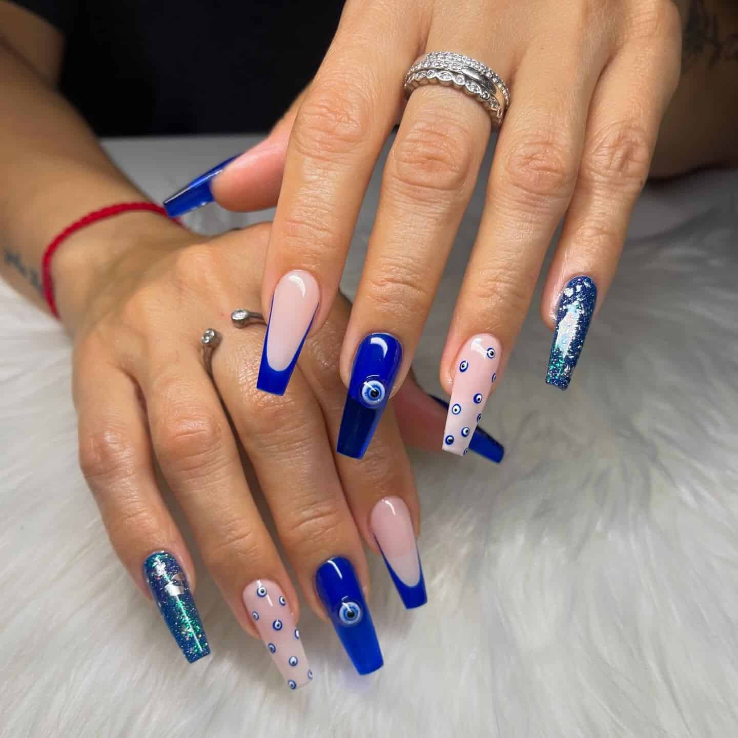 1. Royal Blue Evil Eye Coffin Nails - blue coffin nail ideas