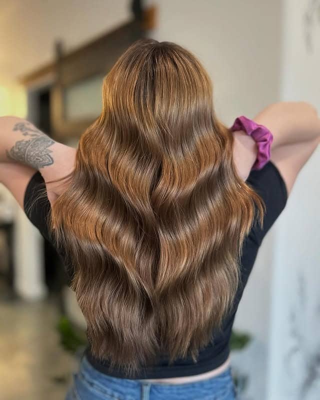 1. Golden Chestnut Waves - Warm Brown Hair Color