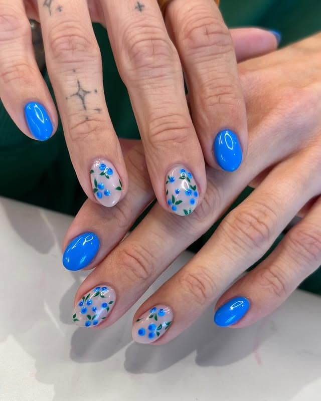 9. Glossy Blue & Green Accents - blue floral nail ideas