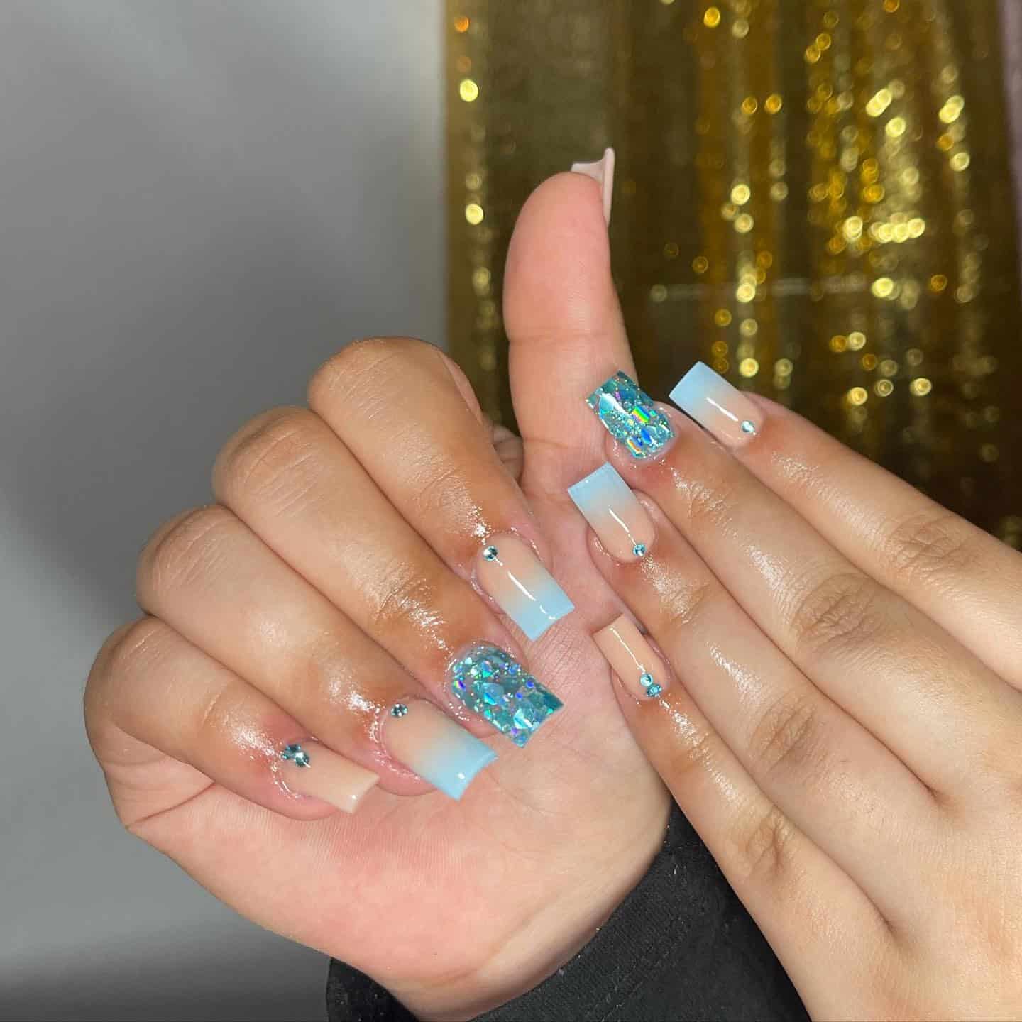 1. Sky Ombre with Crystal Accents - blue glitter nail ideas