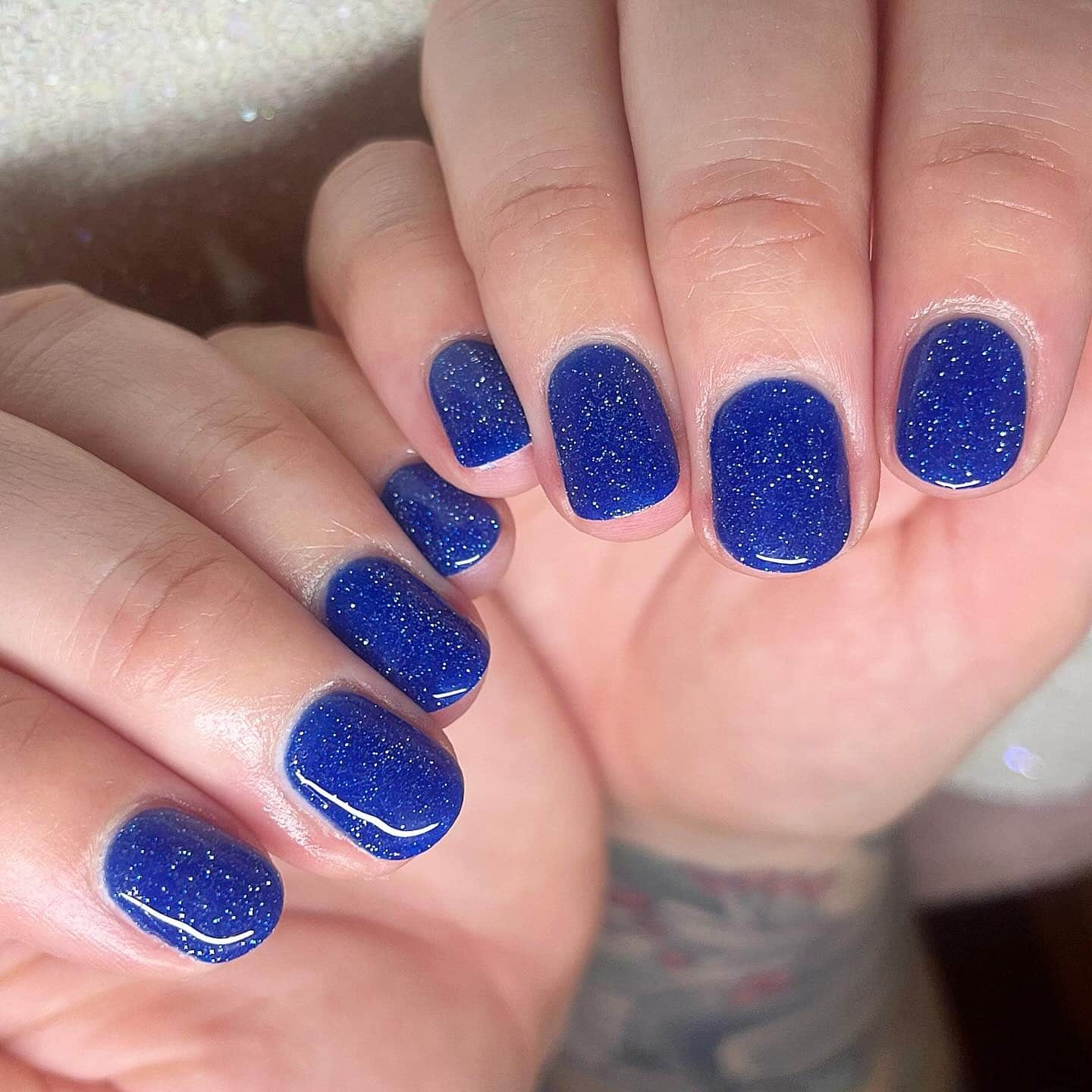 3. Midnight Spark Short Nails - blue glitter nail ideas