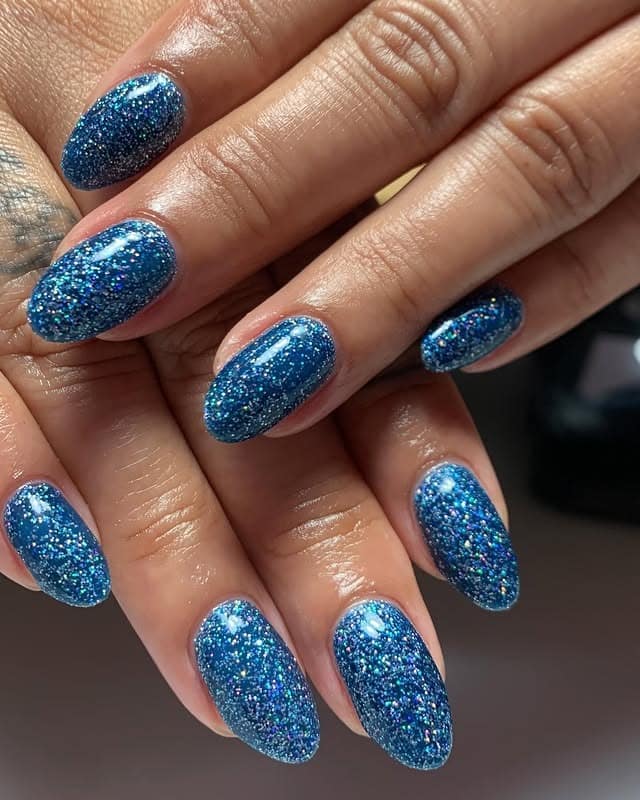 4. Ocean Glitter Almond Nails - blue glitter nail ideas