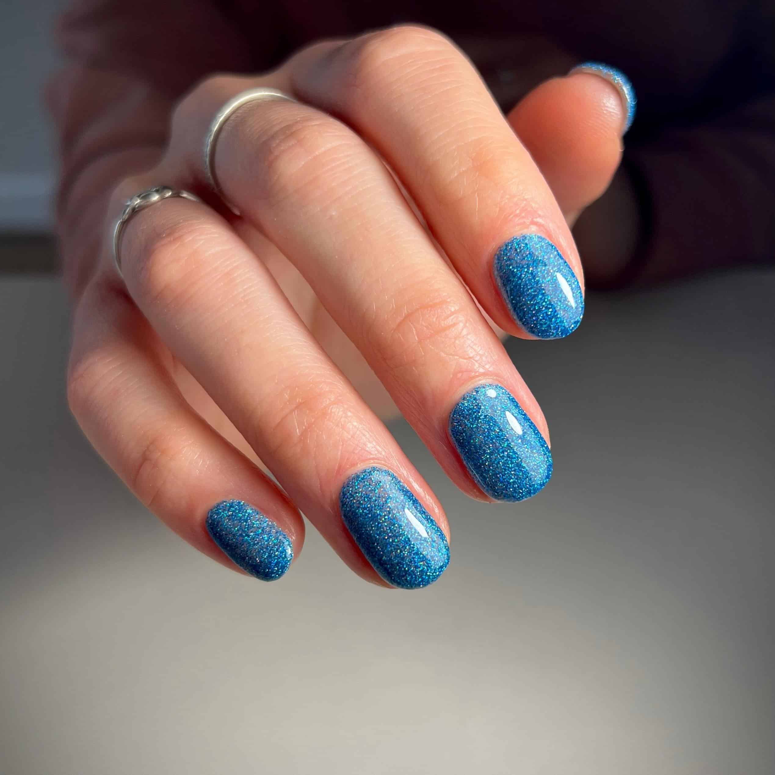 7. Stardust Blue Short Nails - blue glitter nail ideas