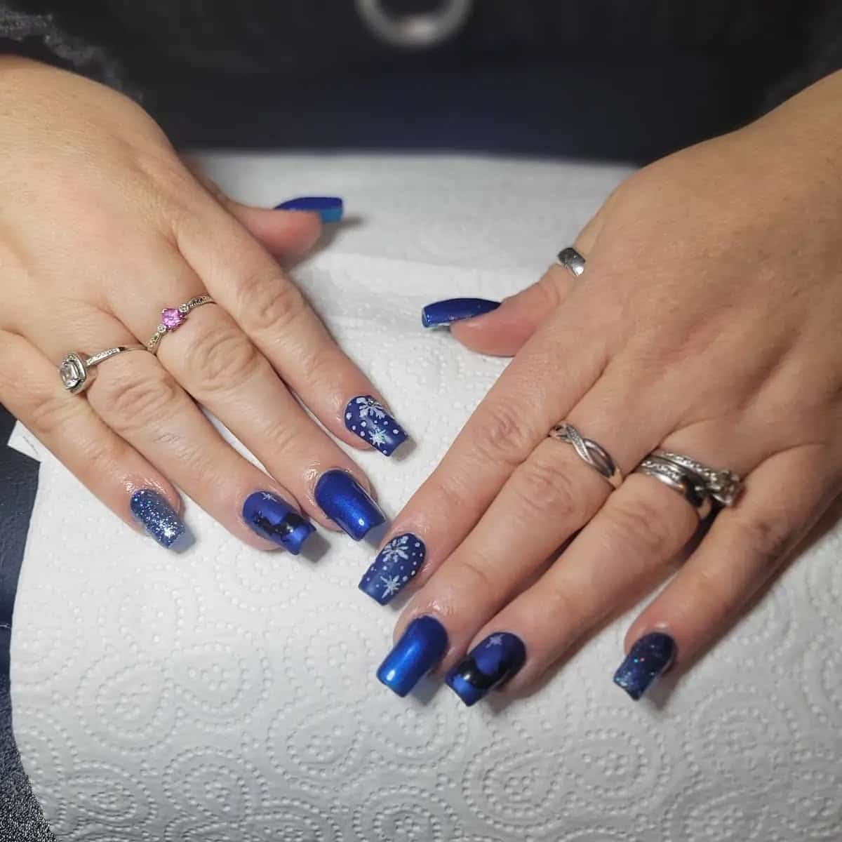 13. Midnight Blue Snowflake Nails - blue glitter nail ideas